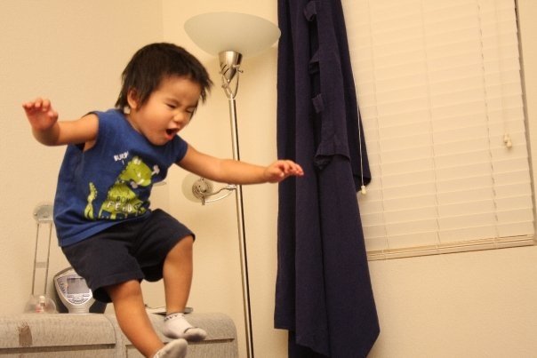 Aidan mid-leap off the couch